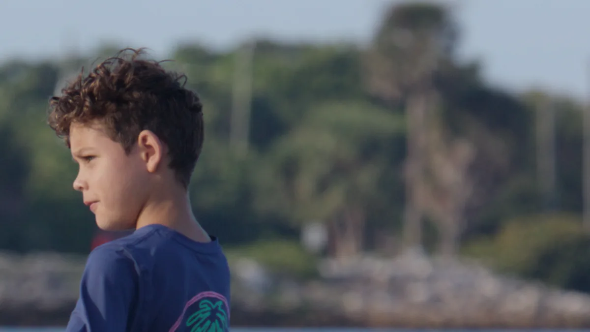 A boy in profile through PursuitLuts Base, natural skin tone.